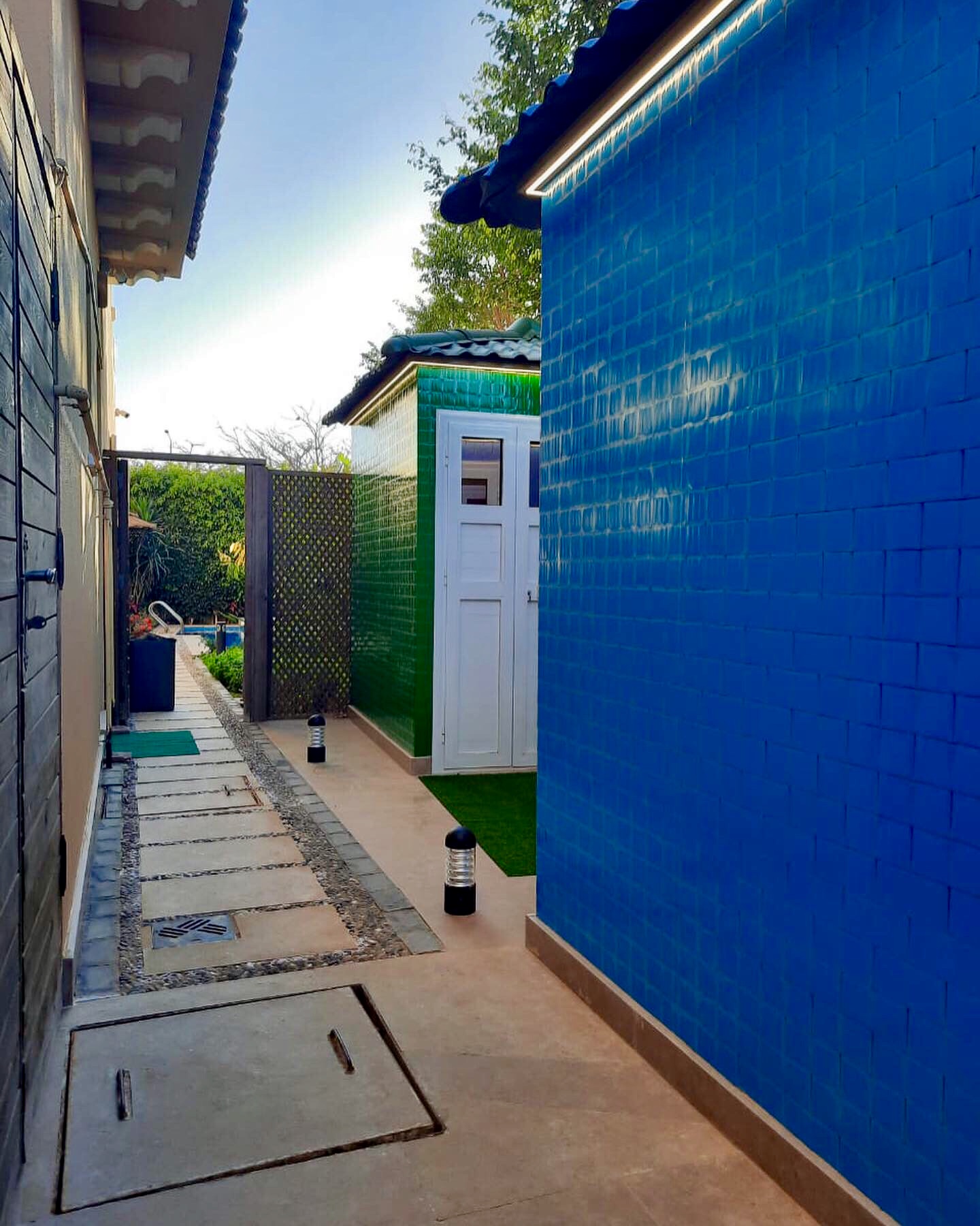 Blue and Green Sheds built by Reblox out of sustainable plastic blocks at Hyde Park Compound in Egypt