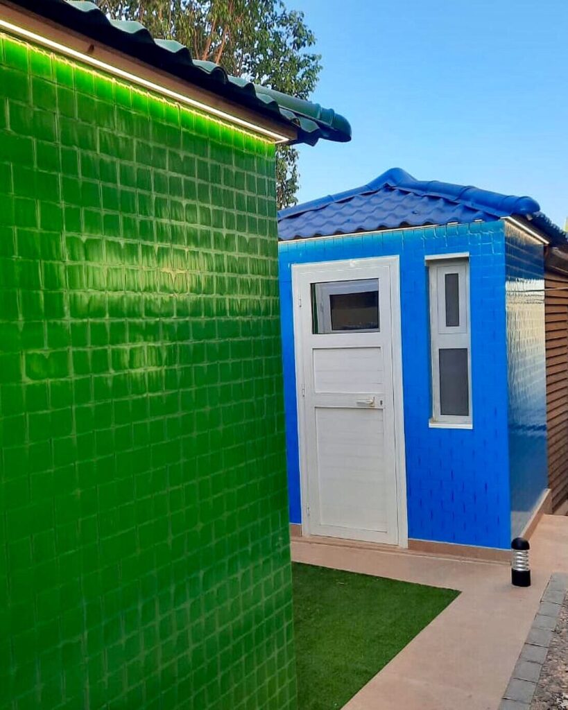 Blue and Green Sheds built by Reblox out of sustainable plastic blocks at Hyde Park Compound in Egypt